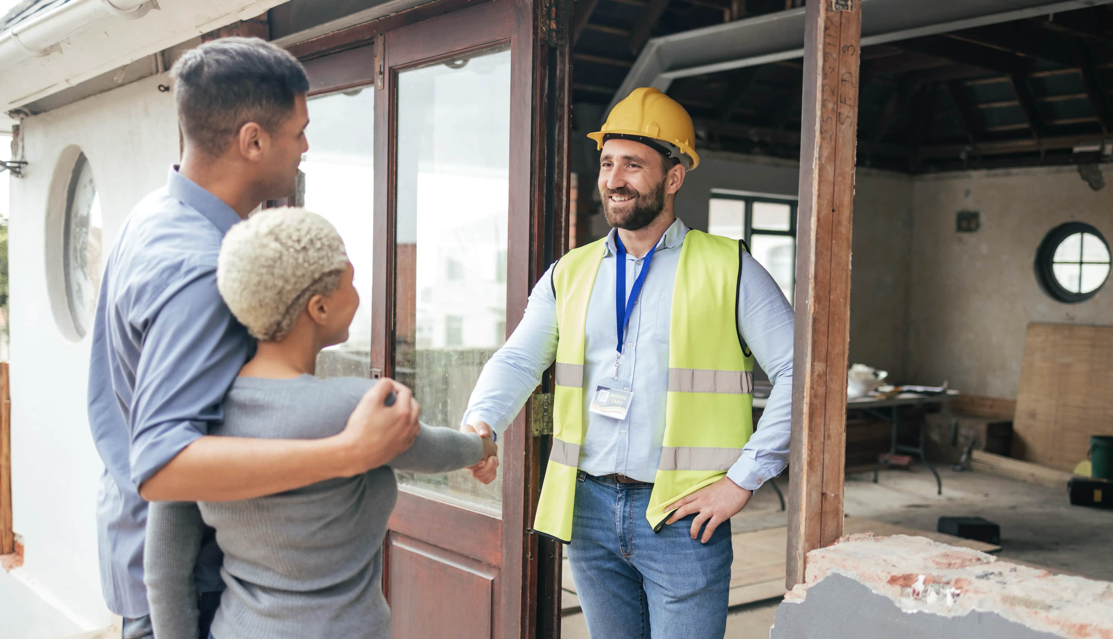 Builder discussing a renovation project with homeowners after winning the work through local SEO