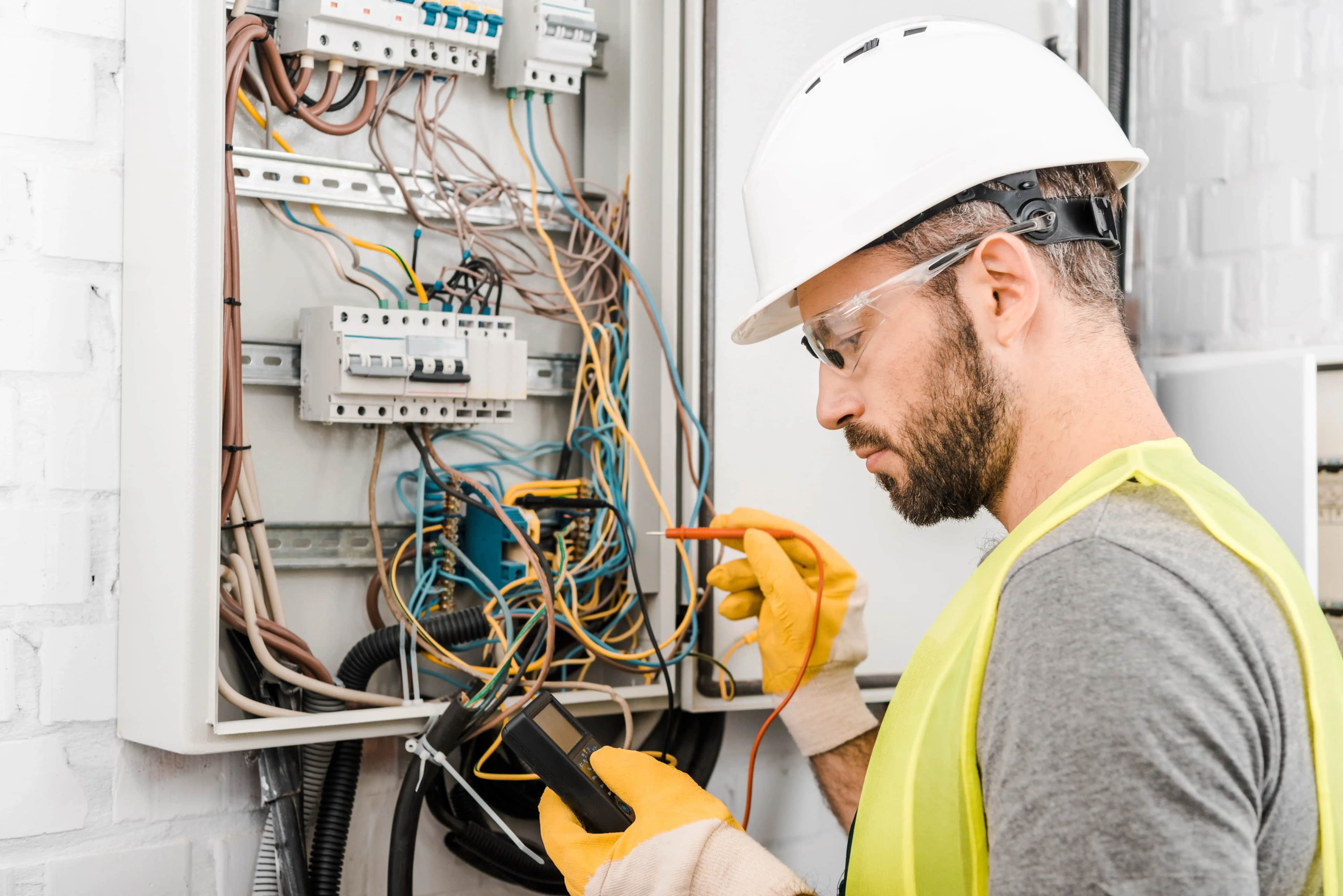 Electrician checking an electrical box with a multimeter on an Adelaide job