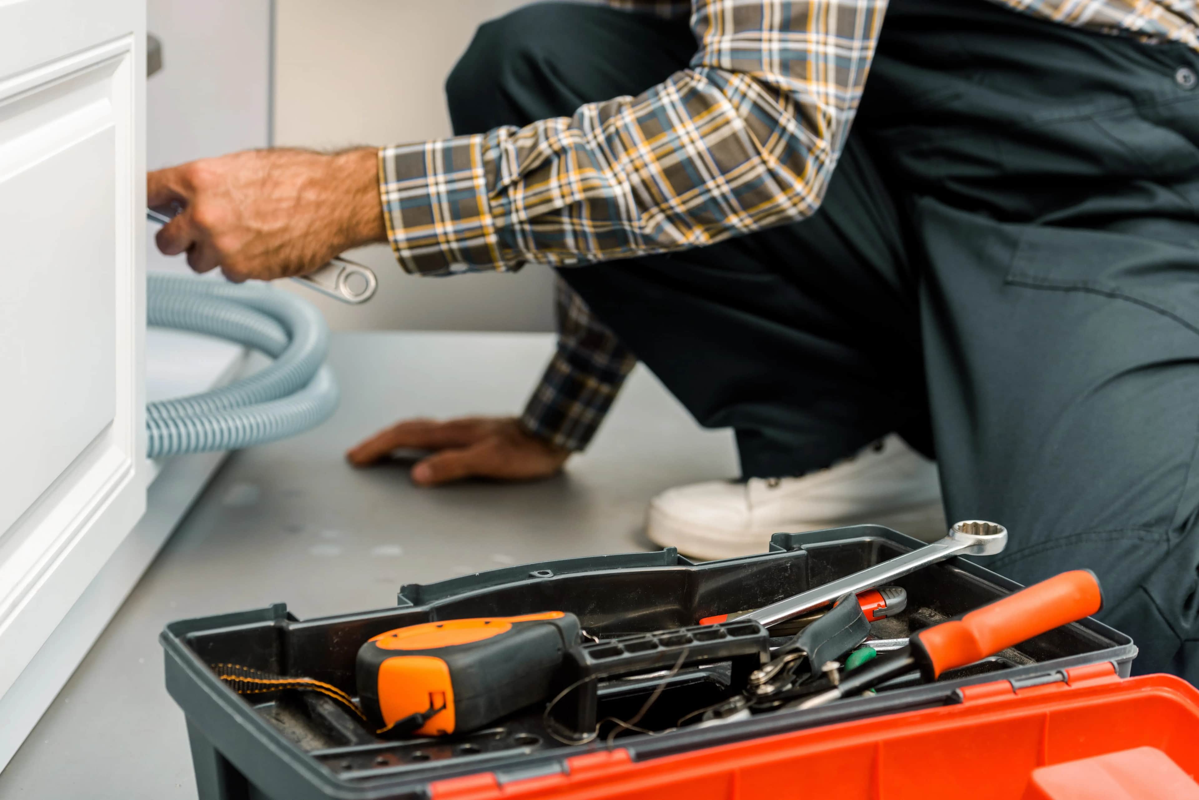 Plumber repairing a broken kitchen sink